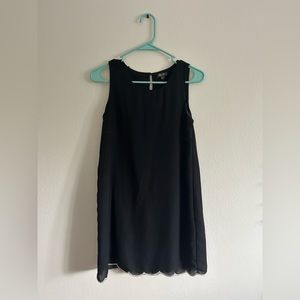 Black dress. Small button on the back. White trim on bottom.